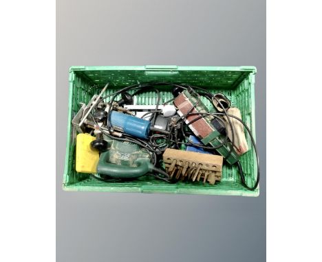 A plastic crate containing power tools by Bosch, Makita and Skil.