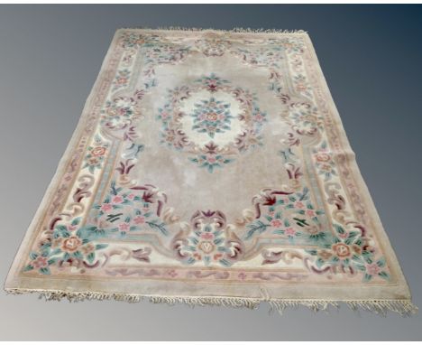 A Chinese floral embossed fringed carpet on beige ground (length 282cm), together with a further fireside rug on green ground