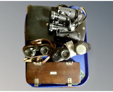 A tray containing three pairs of field glasses including Zenith 12x50, Revue 10x50, Prisma of Paris, two cased, together with