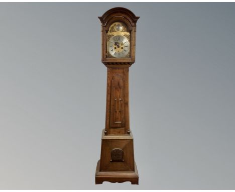 A 19th century continental oak longcase clock with brass and silvered dial, pendulum (AF) and weights, the later brass dial s