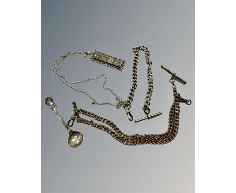 A silver ingot pendant on chain, a silver Albert chain, a further gold plated Albert chain and a silver caddy spoon. 