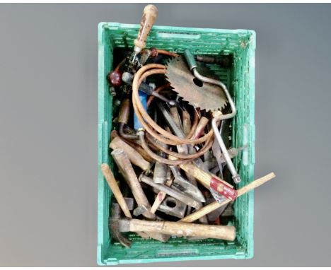 A crate containing a quantity of vintage hand tools including files, hammers, egg beater drill.