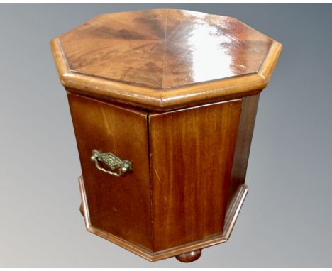 A 19th century octagonal mahogany commode with brass handles.