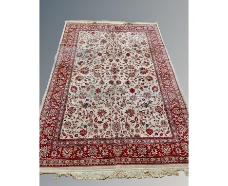 An Isfahan design carpet on red and cream ground, 302 cm x 197 cm