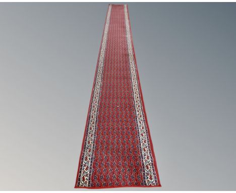 A machine made eastern design runner, 578 cm x 67 cm