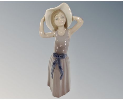 A Lladro figure, girl with hat.
