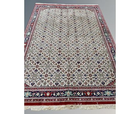 A machine made carpet with all-over Herati motif on cream ground, 354 cm x 247 cm