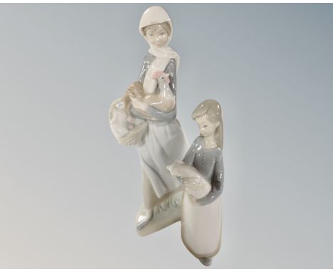 Two Lladro figures, girl with chicken and girl with pig.