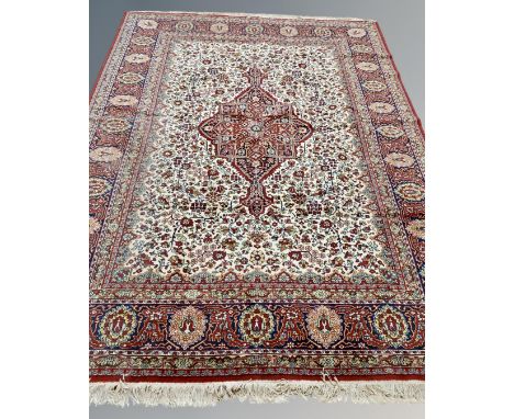 A Heriz-style carpet, probably Indian, on red and cream ground, 335 cm x 252 cm
