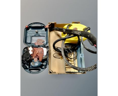 A box containing a pressure washer, Black &amp; Decker mouse sander, a plastic toolbox containing Allan keys and drill bits.