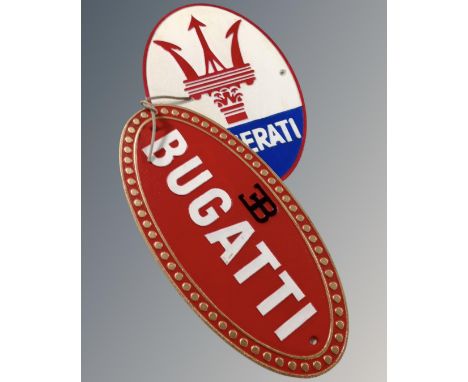 Two cast iron wall plaques, Bugatti and Maserati.
