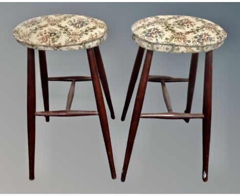 A pair of stained beech bar stools with tapestry seats.