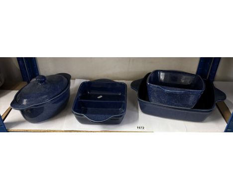 A quantity of  heavy blue glazed cookware including roasting pans