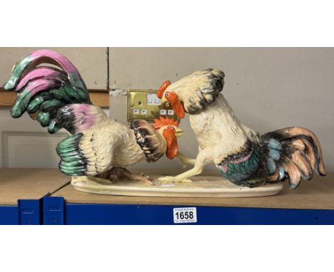 A large ceramic cock fighting figure group, Length 58cm