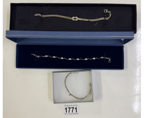 A silver bracelet, silver bangle &amp; a white metal bracelet