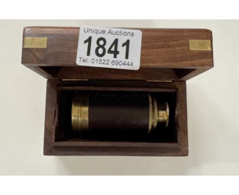 A telescope in wooden box