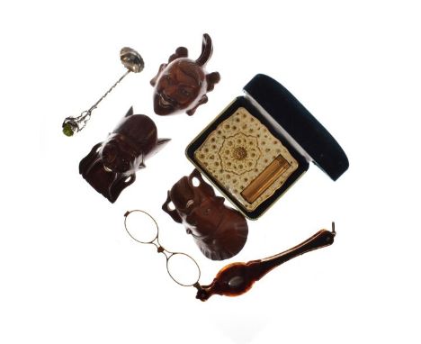 Pair of faux tortoiseshell lorgnettes, three carved wooden Oriental miniature masks, lady's compact and a white metal spoon  