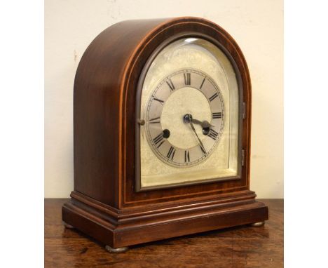 Early 20th Century string inlaid mahogany arch top mantel clock, the silvered dial with Roman numerals, German brass movement