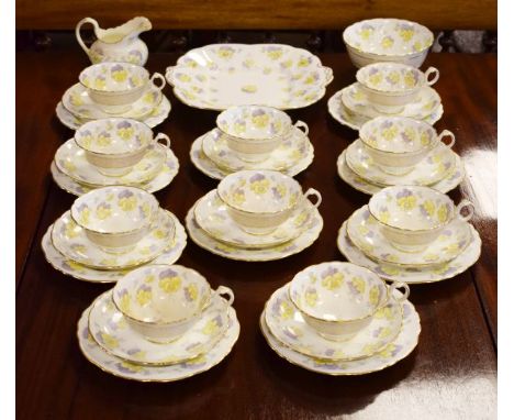 Cauldon ten person tea service having stylised foliate decoration in lilac and yellow   Condition: 