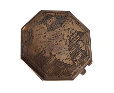 White metal octagonal compact engraved with a map of India inset with ruby coloured stones, the hinged cover revealing a pres