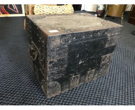 A small black painted, metal bound travel trunk with two handles to side.