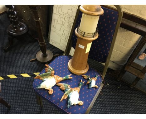 Three Berwick flying ducks together with a model light house.