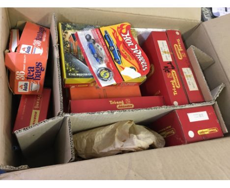 Several boxes of Hotwheels cars and model trains in boxes.