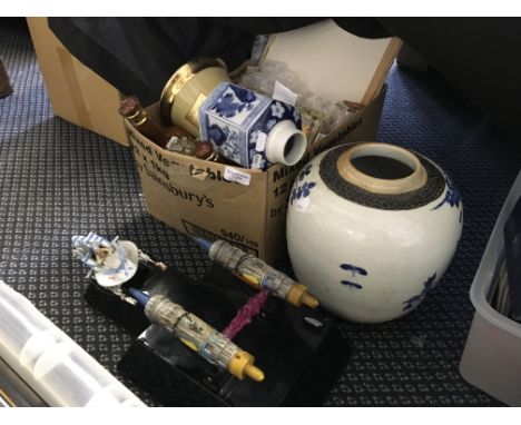 A box containing various pottery as well as a model Star Wars ship on stand.
