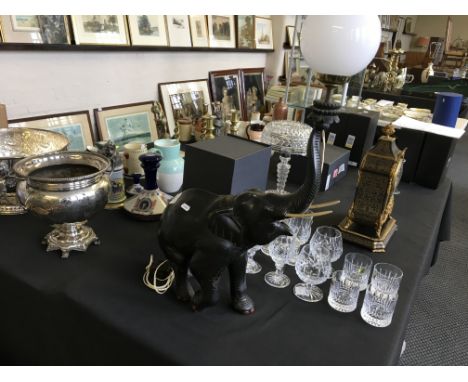 An ebony carved elephant lamp with glass white shade.