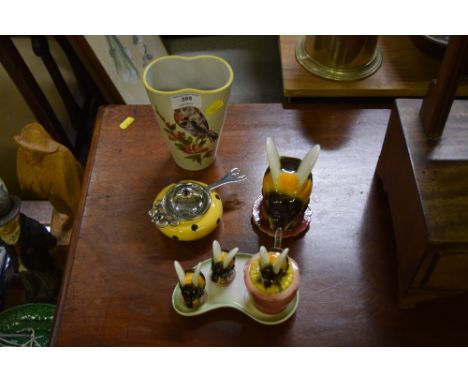 A Goebel cruet set on stand; together with a similar pot and cover; a tea strainer; and a pottery vase