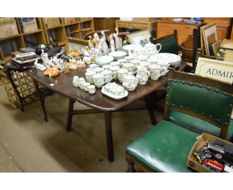 An Ercol drop leaf kitchen table, with a set of four stick back chairs 