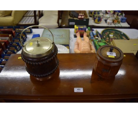 An oak tea caddy; and an oak biscuit barrel containing two miniature time pieces 