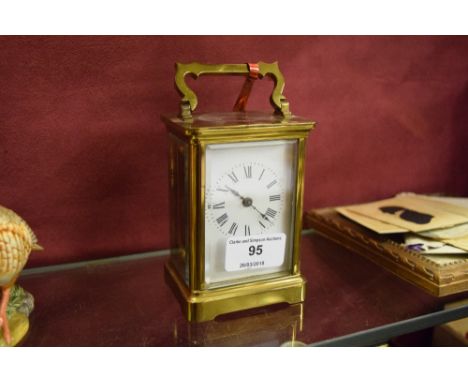 A brass cased carriage clock, the dial signed Eustice Durran