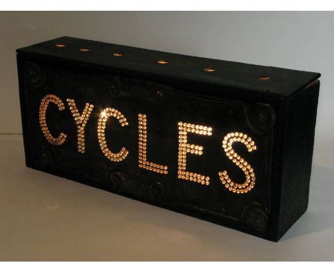 *Cycles. A show room sign and illumination box,  lighting the word 'Cycles' via individual glass beads, within an art nouveau