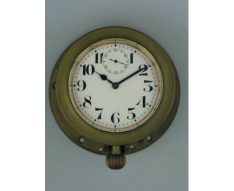 *Mechanical clock as fitted to veteran cars,  a watch held in a brass case with a retaining ring. The 2 3/4-inch white dial w