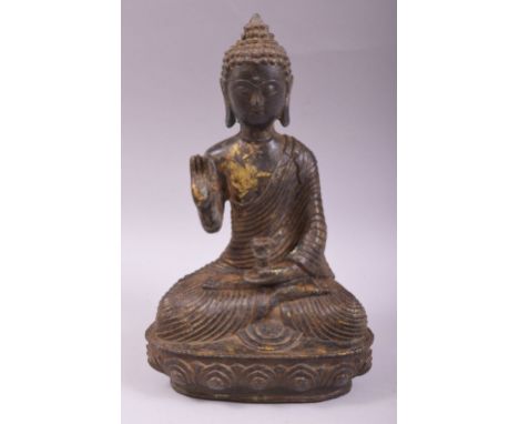 A CHINESE BRONZE MODEL OF A SEATED BUDDHA, with traces of gilt decoration, 24cm high.