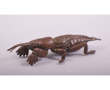 A JAPANESE BRONZE MODEL OF A MOLE CRICKET, stamped underside, 7cm long.