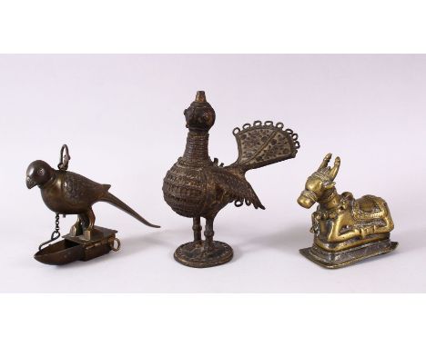 AN INDIAN BRASS NANDI BULL, together with a bird oil lamp and another hanging bird oil lamp, bull 10cm long.