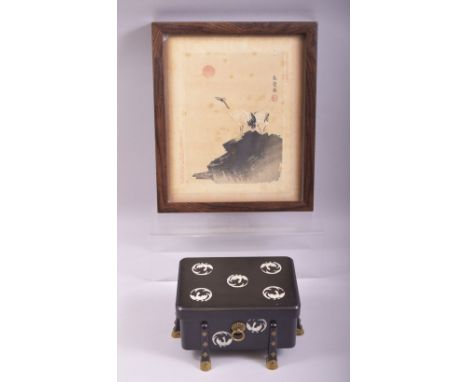 A JAPANESE BLACK LACQUER AND MOTHER OF PEARL INLAID BOX AND COVER, supported on eight feet with brass fittings, together with