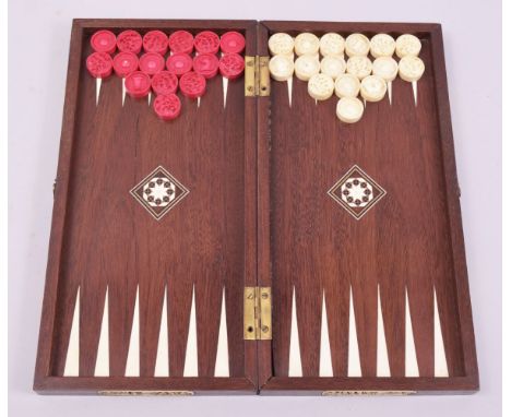 A SET OF CHINESE SIXTEEN STAINED RED AND SIXTEEN WHITE COUNTERS, 2.5cm, carved with figures and chess pieces in an inlaid che