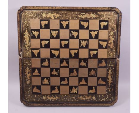 A VERY GOOD 19TH CENTURY GILT AND LACQUERED FOLDING CHESS BOARD, interior with backgammon board, 50cm wide.