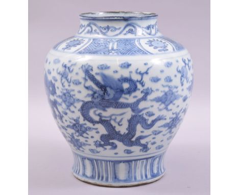 A CHINESE BLUE AND WHITE PORCELAIN JAR, painted with dragons and the flaming pearl of wisdom amongst stylised cloud form moti