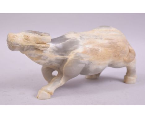 A CHINESE HARDSTONE OR WHITE JADE CARVING OF A BUFFALO, 23cm long.