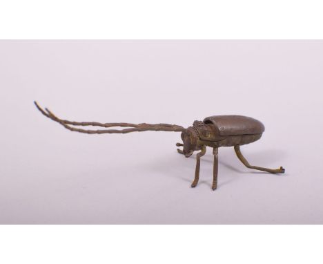 A JAPANESE BRONZE MODEL OF A LONG HORNED BEETLE, with hinged back, 14.5cm long.