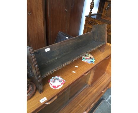 An oak single shelf bookcase with carved Lancashire rose crests 