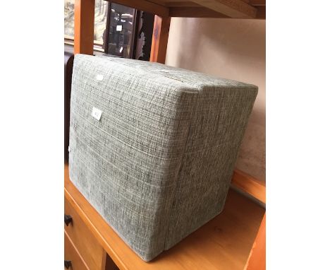 A green upholstered pouffe 