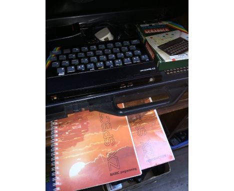 Case containing ZX spectrum, games and instructions manual 