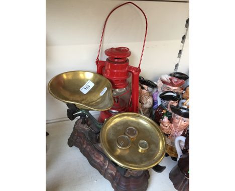 Brass and iron scales and a storm lamp 