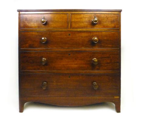An early 19th century mahogany chest of two over three graduated drawers, the reeded, moulded top over the cockbeaded drawer 