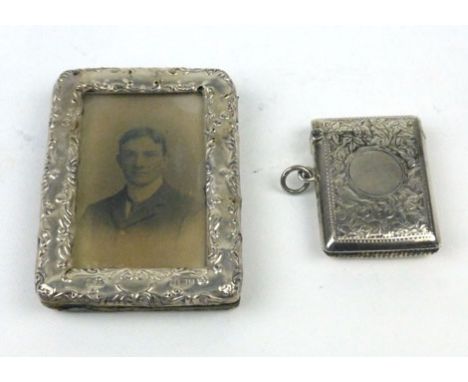 A silver hallmarked picture frame together with a silver hallmarked vesta case of various dates